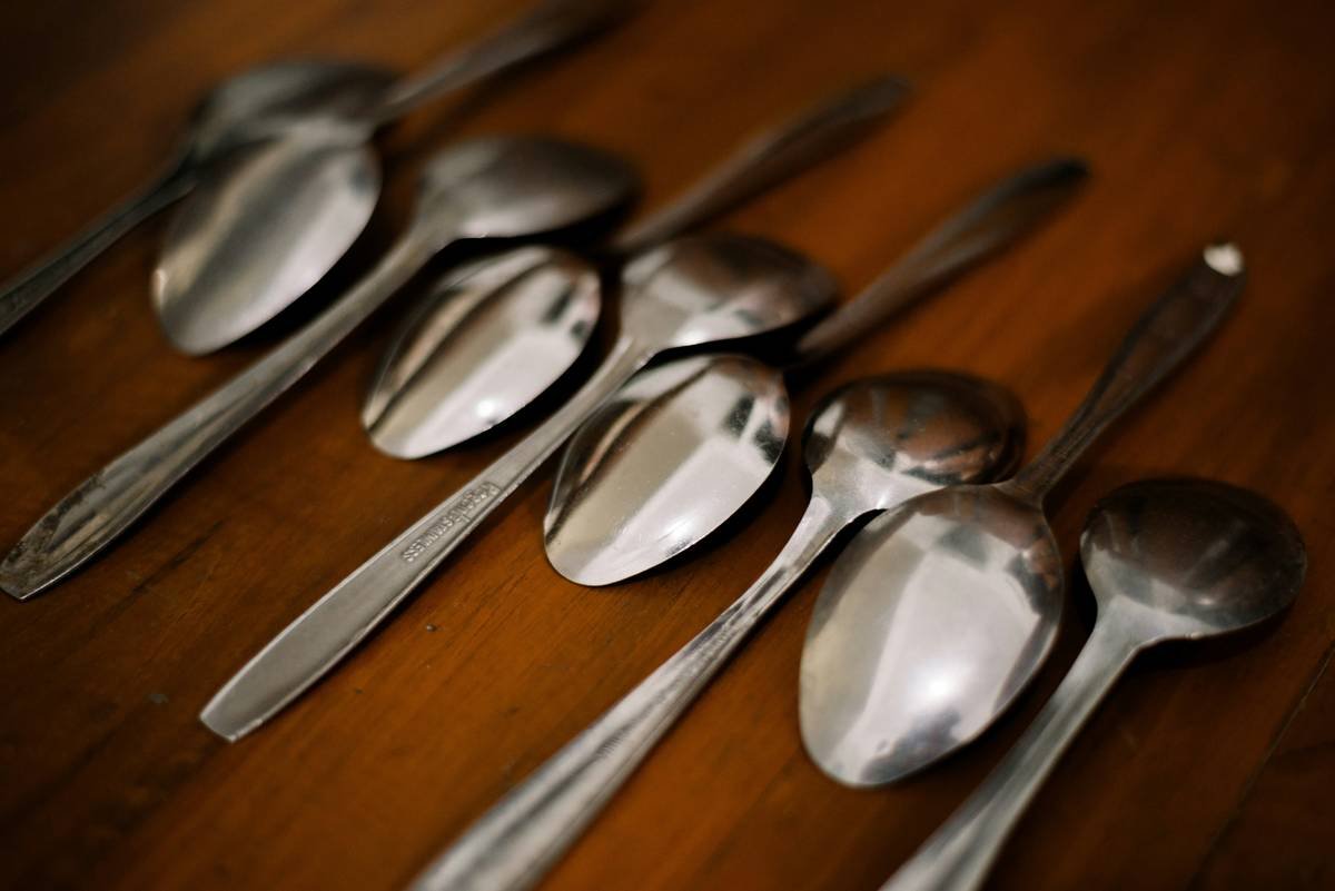 Close-up of tools candy thermometer spoon showing embedded digital sensor and slotted stainless steel bowl for accurate candy making