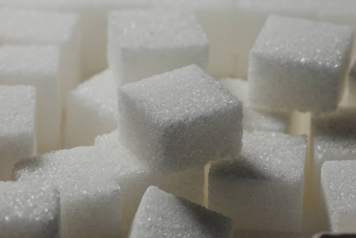 hand testing candy consistency using cold water method for making candy without a candy thermometer